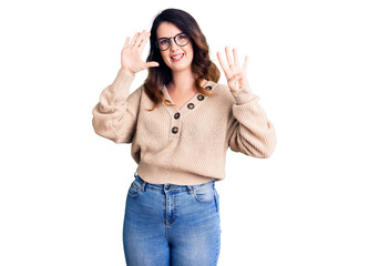 Beautiful young brunette woman wearing casual clothes and glasses showing and pointing up with fingers number nine while smiling confident and happy.