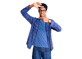 Young african american man wearing casual clothes and glasses smiling making frame with hands and fingers with happy face. creativity and photography concept.
