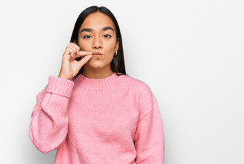 Young asian woman wearing casual winter sweater mouth and lips shut as zip with fingers. secret and...