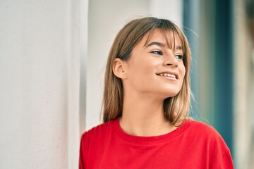 Caucasian teenager girl smiling happy standing at the city.