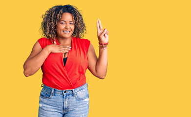 Young african american plus size woman wearing casual style with sleeveless shirt smiling swearing with hand on chest and fingers up, making a loyalty promise oath