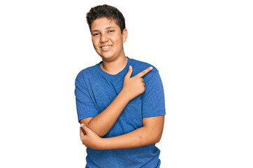 Teenager hispanic boy wearing casual clothes cheerful with a smile of face pointing with hand and...