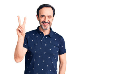 Naklejka premium Middle age handsome man wearing casual polo smiling with happy face winking at the camera doing victory sign. number two.