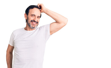 Fototapeta premium Middle age handsome man wearing casual t-shirt smiling confident touching hair with hand up gesture, posing attractive and fashionable