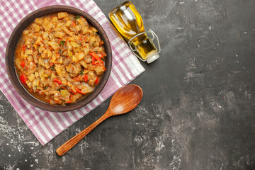top view roasted eggplant salad in bowl on dark wooden spoon oil bottle background free space