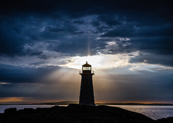 Peggy's Cove lighthouse at sunset with storm clouds © Gerald Zaffuts