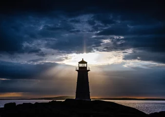 Foto op Aluminium Peggy's Cove lighthouse at sunset with storm clouds © Gerald Zaffuts
