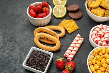 front view different eatings crackers fruits and candies on grey background sweet tea crisp