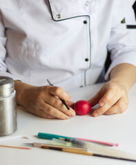 Making heart shape from gumpaste for valentines's.Cake decoration process. Baker uses the tools for...