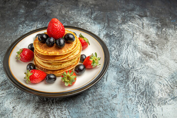 front view delicious pancakes with fruits and berries on dark desk cake fruit dessert