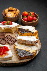front view cake slices with cookies and fruits on dark background pie biscuit sweet