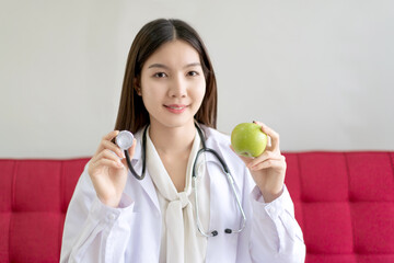 Unrecognizable Asian expert nutritionist showing an organic green apple close up