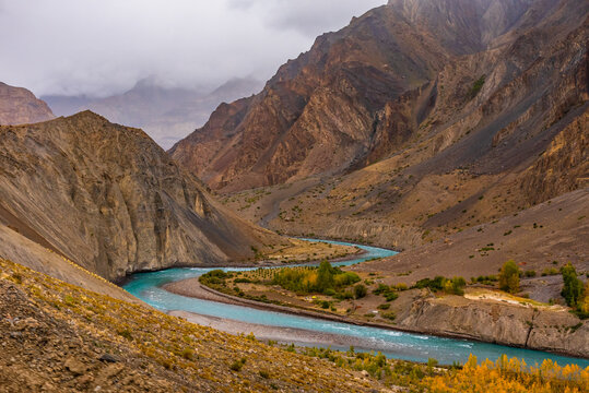 Meander is one of a series of regular sinuous curves in a river, produced by river as it erodes the sediments from outer concave cut bank and deposits sediment downstream on an inner convex bank.