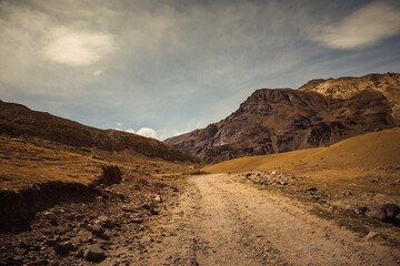 Beautiful view of cold desert arid landscape enroute off road connecting Kaza town with Chandratal Lake passing through Kunnzum Pass in Lahaul Spiti region of Himalayas in Himachal Pradesh, India.