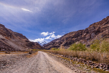 Beautiful view of cold desert arid landscape enroute off road connecting Kaza town with Chandratal Lake passing through Kunnzum Pass in Lahaul Spiti region of Himalayas in Himachal Pradesh, India.