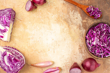 Fototapeta na wymiar top view preparation of red onions and cabbage for homemade beetroot salad on a wooden background with copy space