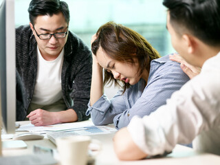 young asian business woman appearing to be frustrated during a discussion in office