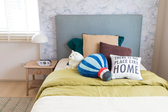 Cute Bear Doll On Boy Bedroom With Side Table Lamp And Clock.