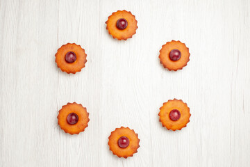 top view delicious cakes with grapes on white background dessert biscuit pie cookies