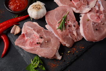 Raw fresh  ossobuco meat on a table with spices and herbs.. Ingredients for Italian stew
