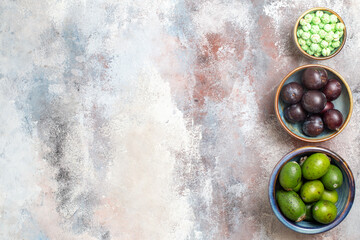 top view fresh plums with feijoas and candies on light background photo fruit fresh