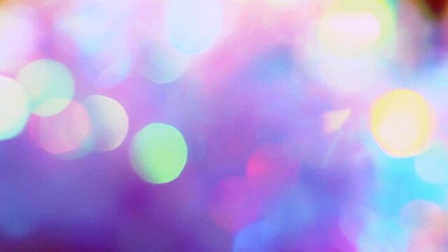 Crystal prism refracting light in vivid neon colors glow. Glass pastel purple pink teal holographic background. Festive background, beautiful romantic glamorous, glitzy bokeh