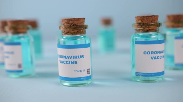 Flu measles coronavirus vaccine. Covid-19 coronavirus vaccine production line, cinematic close up of vaccination manufacturing. Vial. Biontech pfizer moderna novavax curevac astrazeneca vaccination.