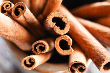A close up image of several sticks of cinnamon in a bunch. 