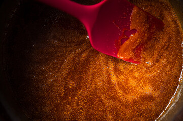Caramel cooking in a saucepan with a spatula
