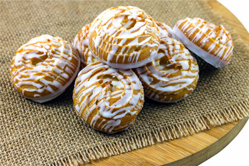 Delicious choux pastry with cream fondant for tea on a wooden kitchen board.