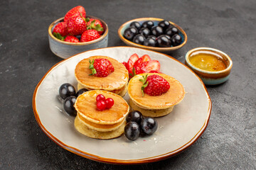 front view yummy pancakes little formed with fruits on grey background pie fruit cake