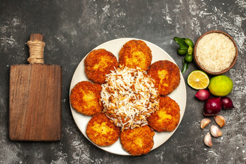 top view fried cutlets with cooked rice on dark floor food dish meat rissole