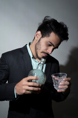 Closeup of a man's hand and pouring wine into the glass. Office party concept