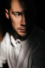 young attractive man looking and thinking. portrait of handsome man sitting in cafe