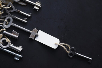 Set of vintage keys for a lock. Retro keys on a dark stone background. The concept of choosing the...
