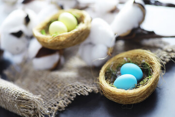 Fototapeta na wymiar Bird's nest with eggs. Willow branches and first greens. Easter background. Palm Sunday. Christian holiday. Spring background.