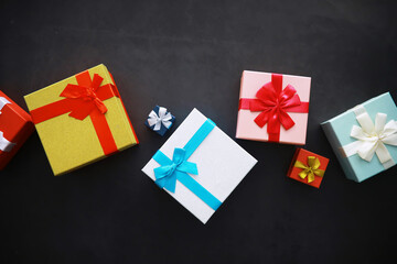 Christmas decoration. Gift boxes on black stone  background. Christmas greeting card concept.