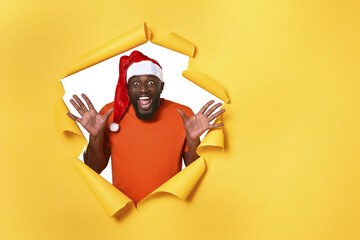 Afro man with hat is happy because is Christmas. Yellow background