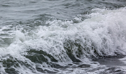 Wave in the sea with splashing water.
