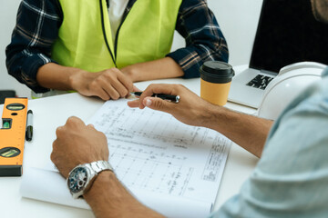 engineer, architect, construction worker team working and planning on drawing blueprint on workplace desk in meeting room office at construction site, contractor, teamwork, construction concept