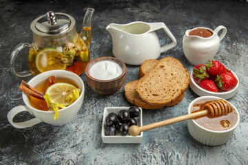 front view fresh strawberries with tea bread and honey on dark background fruit sweet food