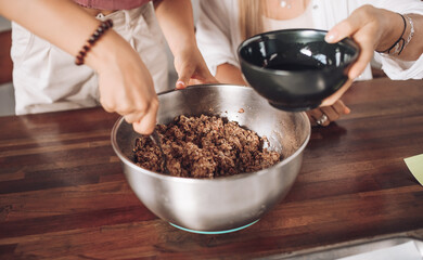 Girls bake oatmeal cookies at home