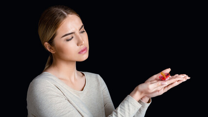 Prohibition on child birth, infertility. Desperate woman looks at pacifier in hands