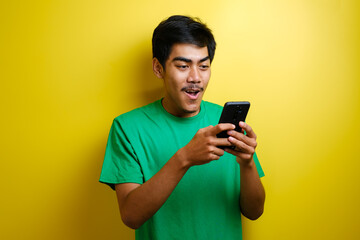 Attractive young Asian man have good news on his phone