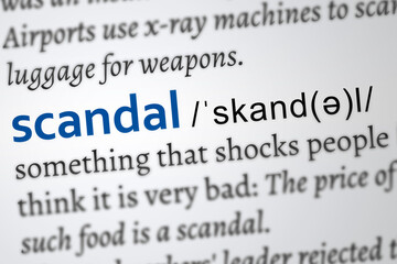 scandal word, definition printed in blue color
