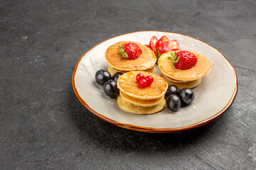 front view yummy pancakes little formed with fruits on grey desk fruit cake pie