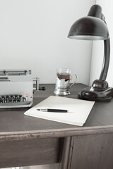 Mechanical calculator, old desk lamp on vintage desk. Accounting and auditing.