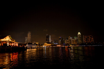 Fototapeta premium Landscape Singapore at night. Landscape of Singapore building around Marina bay with shadow reflection. Modern high building in business district area at twilight.