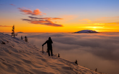 Beautiful sunset over sea of clouds. Winter landscape