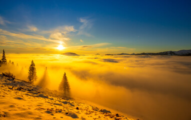 Beautiful sunset over sea of clouds. Winter landscape